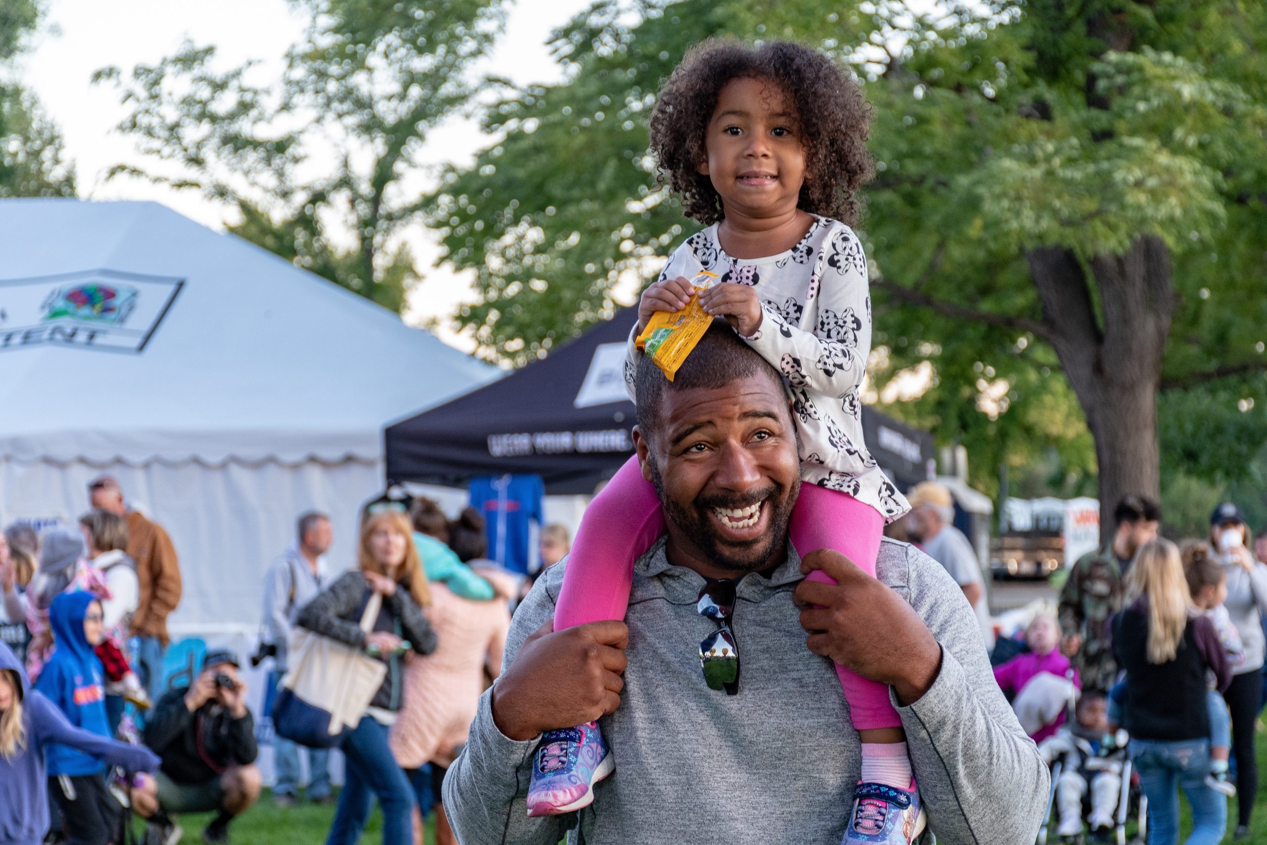 father and daughter having fun at festival